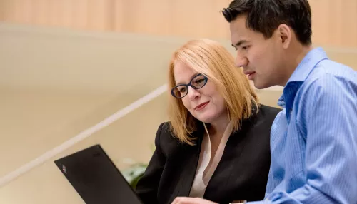 Woman and man looking at laptop