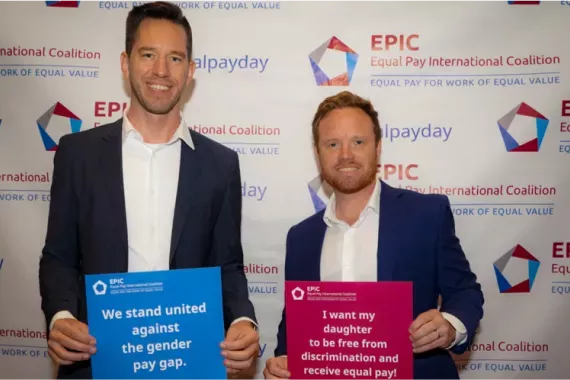 Two men holding signs