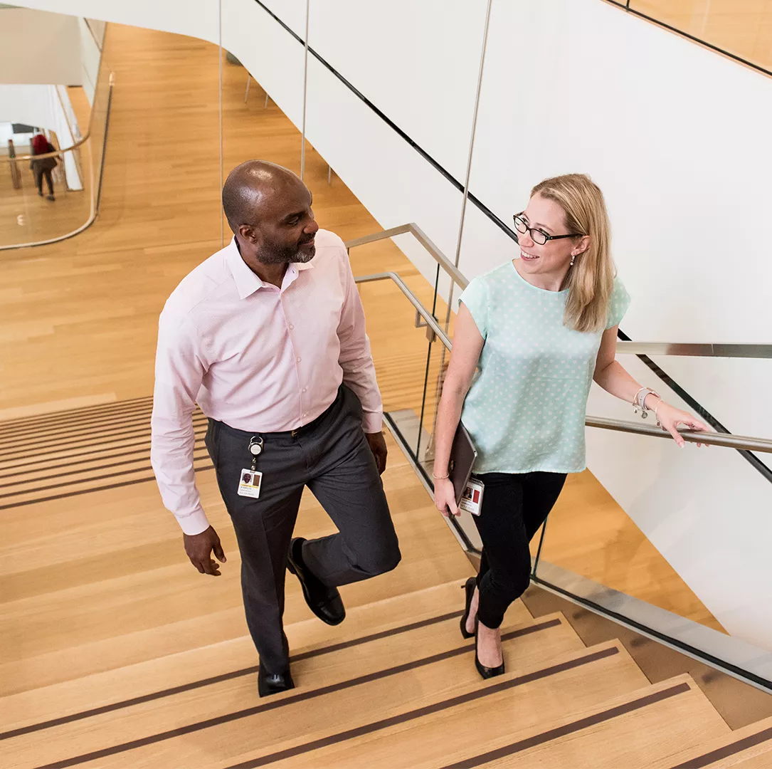 Two Novartis associates walking up a set of stairs